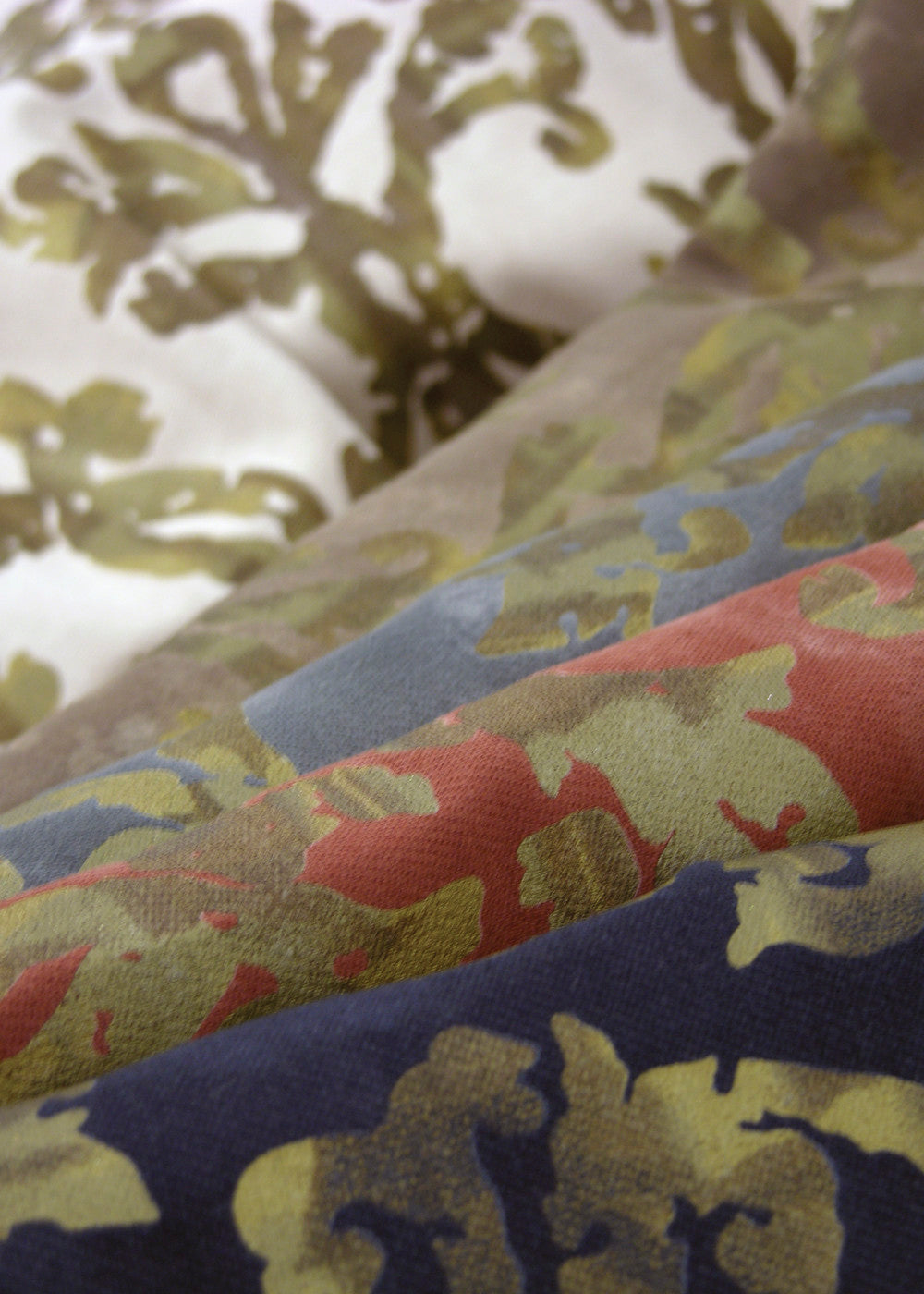 stack of fabrics printed with a metallic gold design