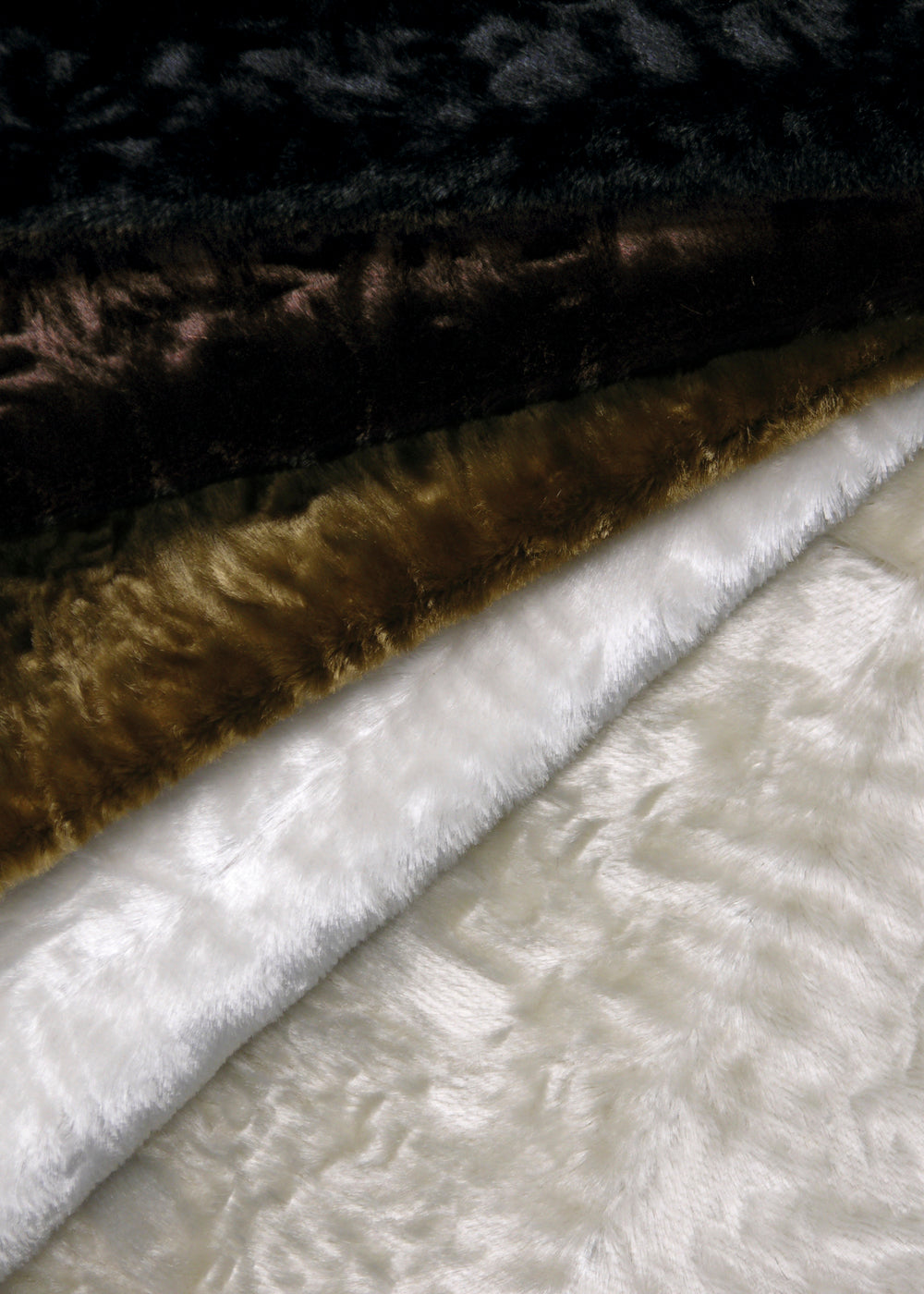 stack of fluffy faux fur fabrics in neutral colors