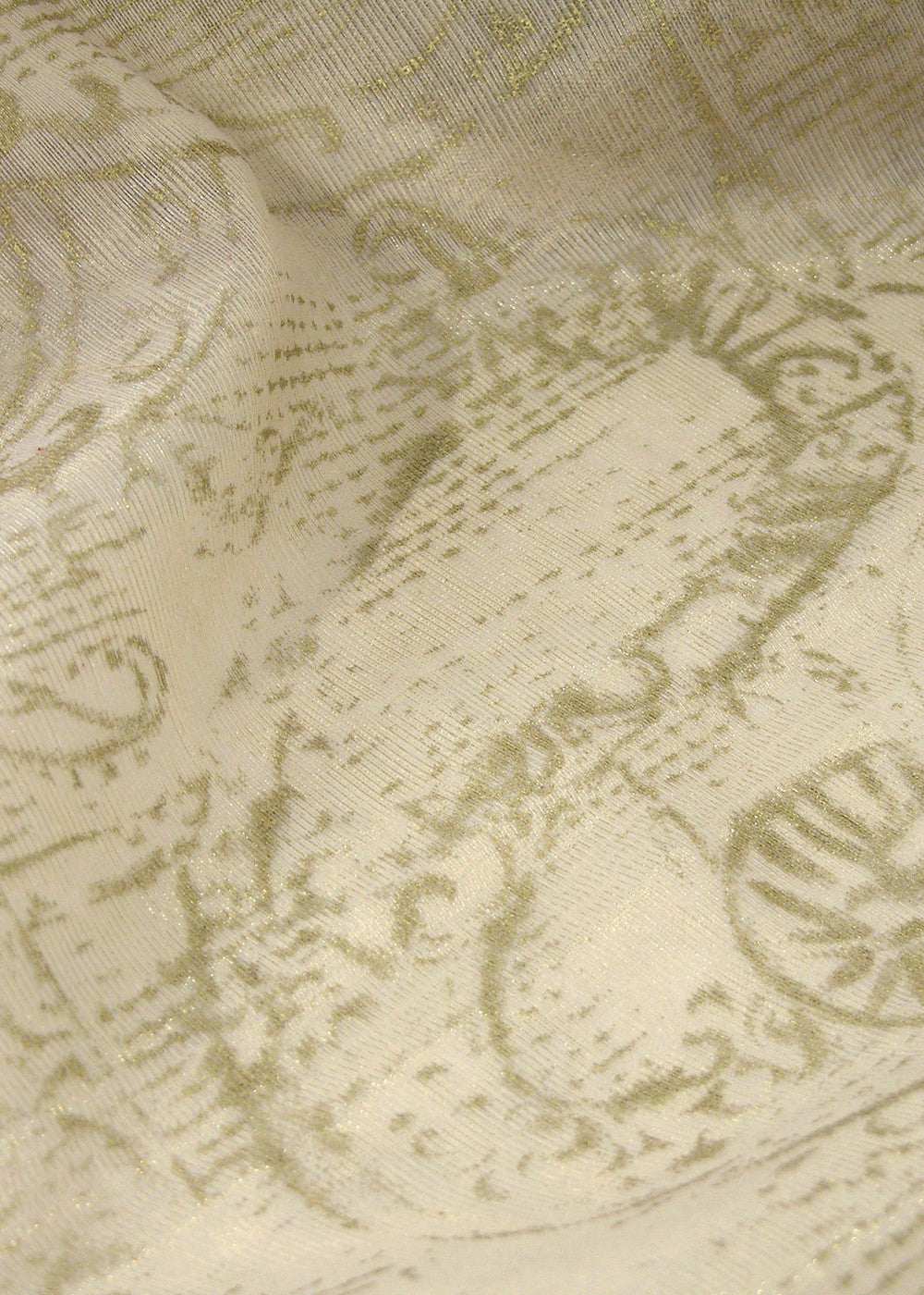 ivory fabric with a metallic gold stamped pattern