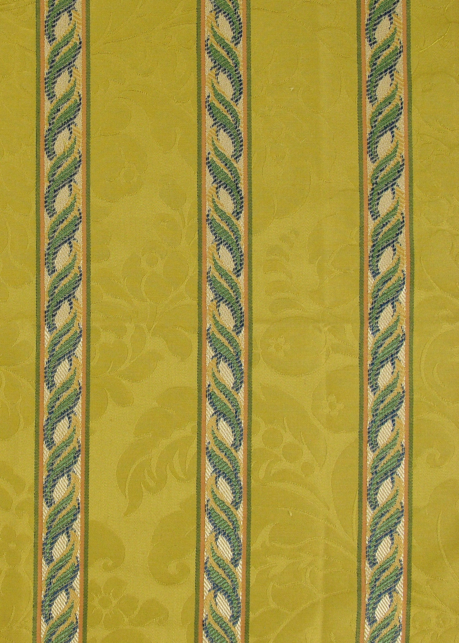 golden yellow fabric with a damask pattern and vertical stripes