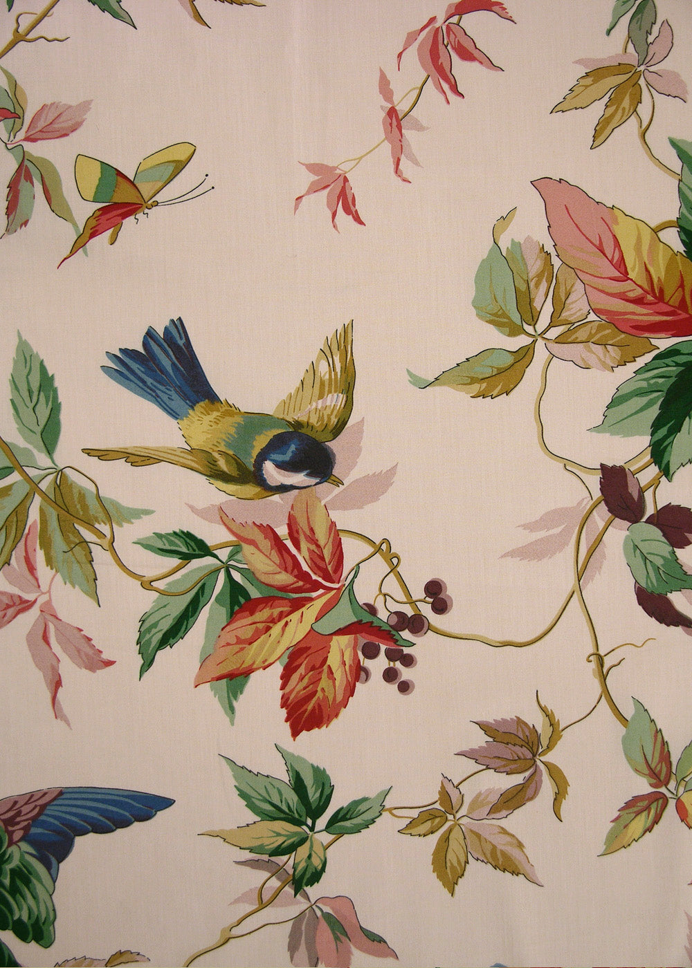 pink fabric that is printed with playful birds, butterflies, and flowers