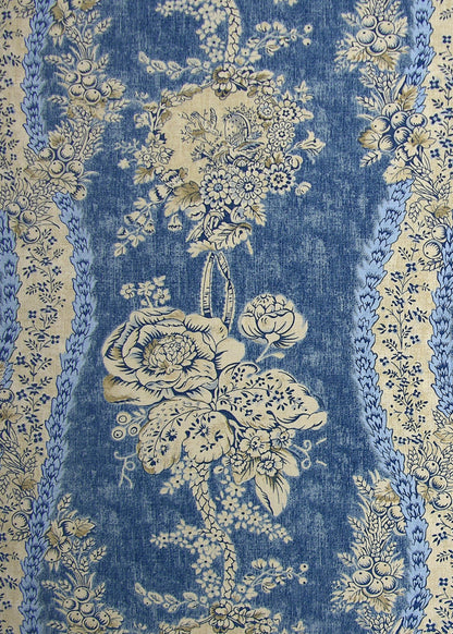 blue fabric with a monochromatic pattern of florals, vines, and berries