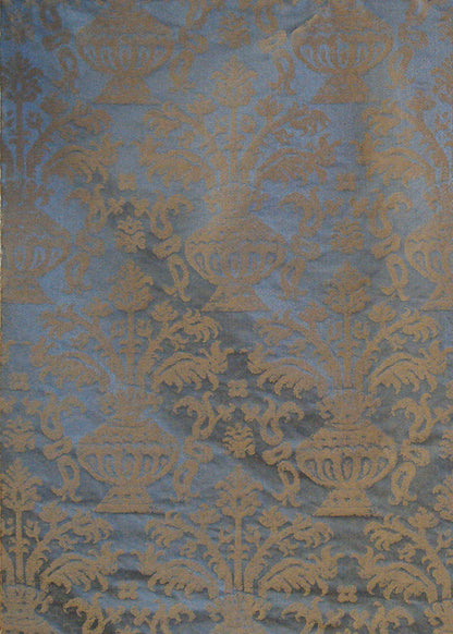 blue and gold fabric with a damask pattern that depicts an abstract vase holding branches