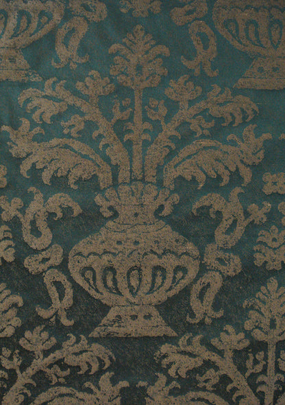 green fabric with a damask pattern that depicts an abstract vase holding branches