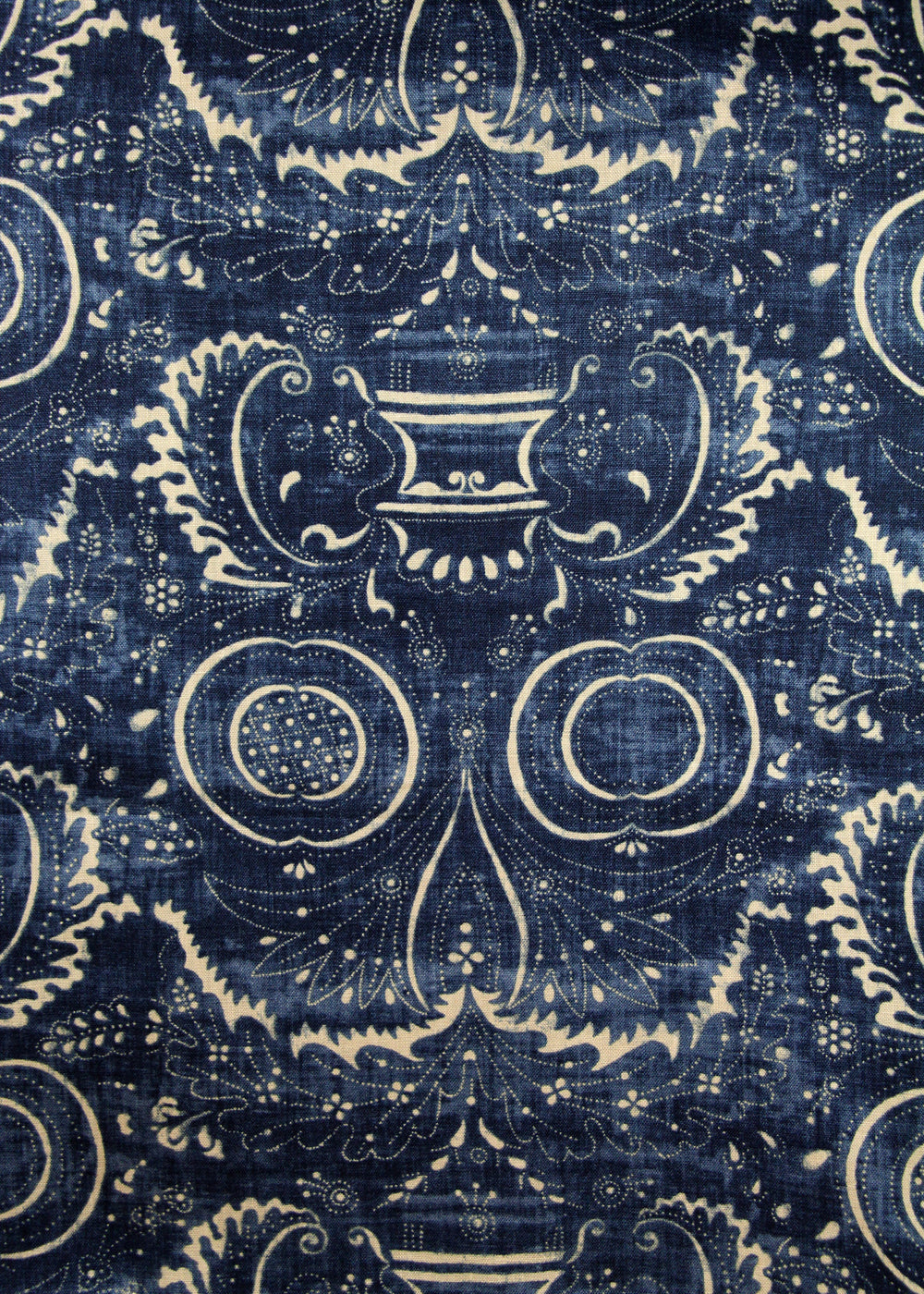dark blue fabric with a swirly printed pattern