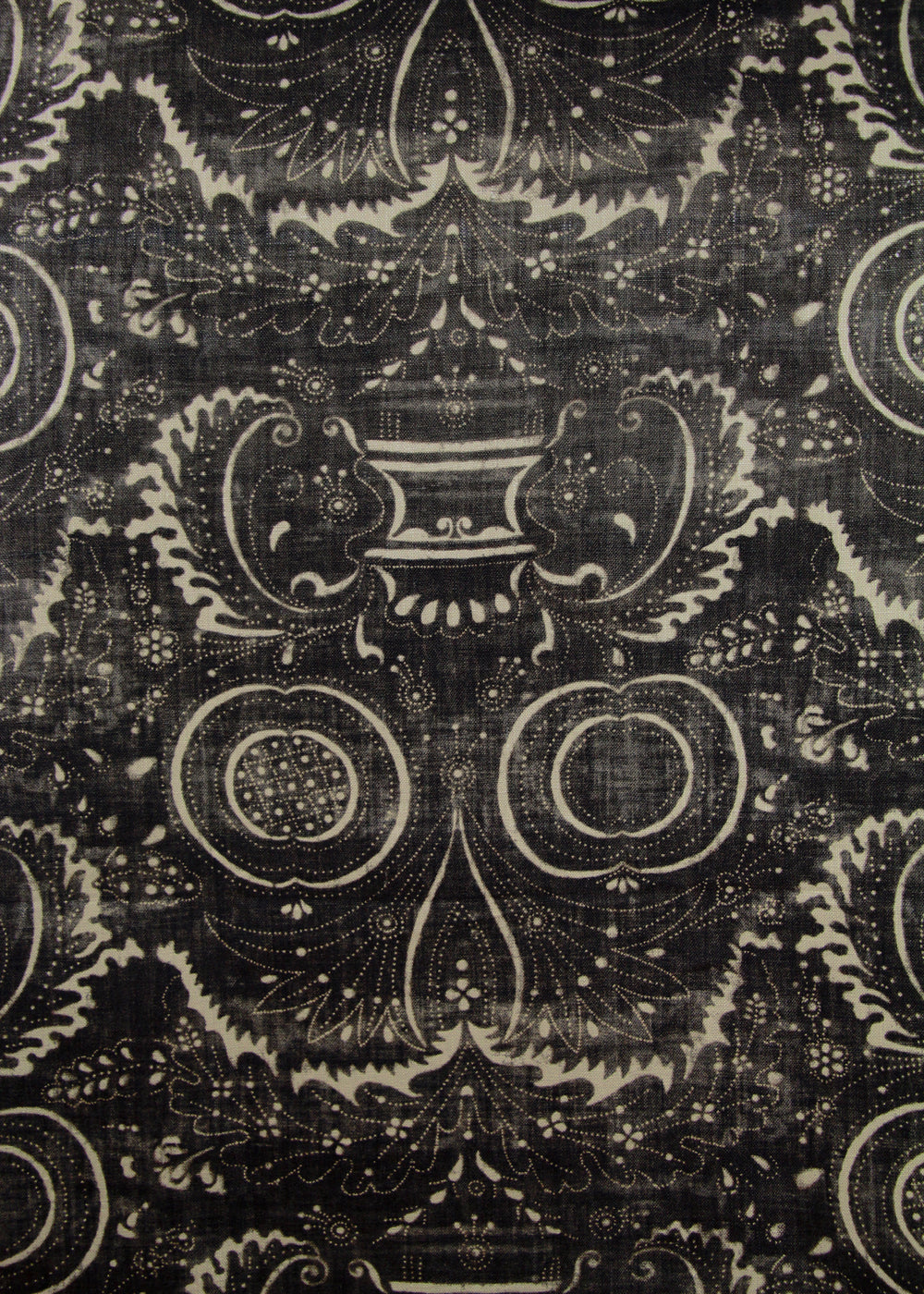 black fabric with a swirly printed pattern