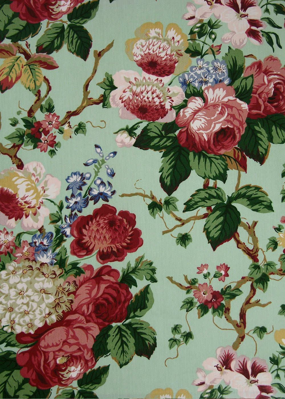 chintz fabric with printed roses and vines on a mint green background
