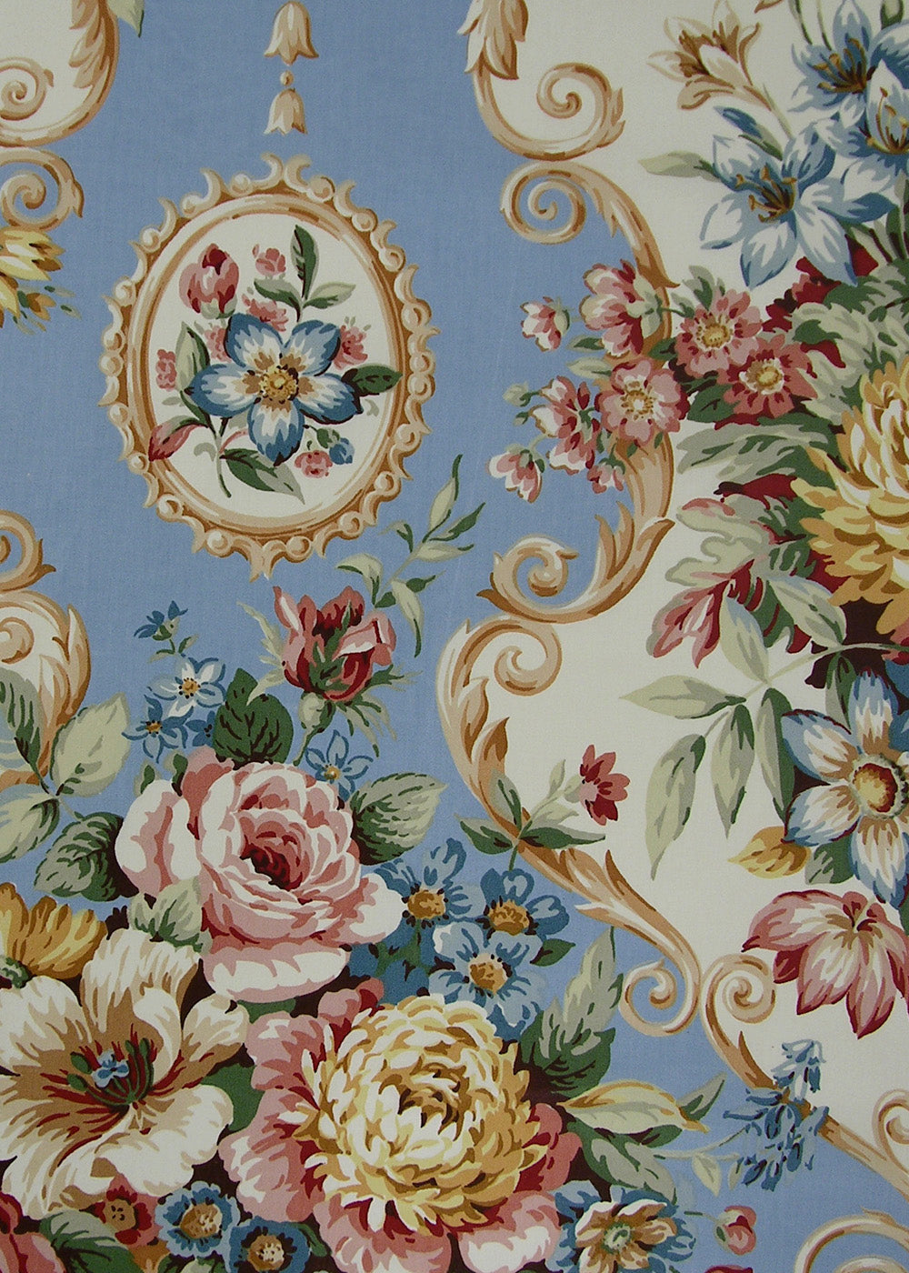 chintz fabric printed with baroque scrolls, multicolored flowers, and frames on a sky blue background