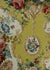 chintz fabric printed with baroque scrolls, multicolored flowers, and frames on a yellow background