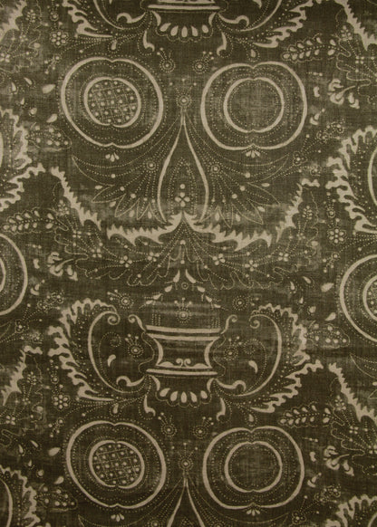 dark olive green fabric with a swirly printed pattern