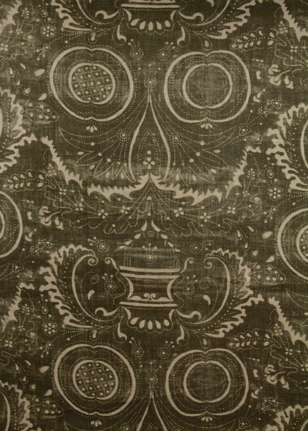 dark olive green fabric with a swirly printed pattern