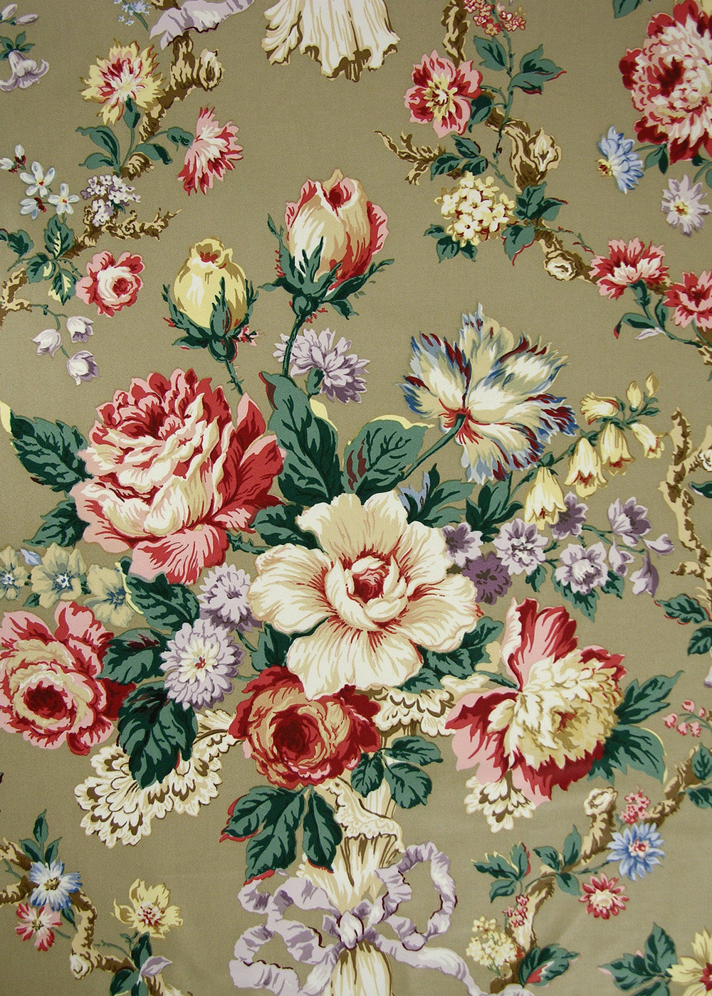 chintz fabric printed with roses, ribbons, and floral vines on a dark taupe background