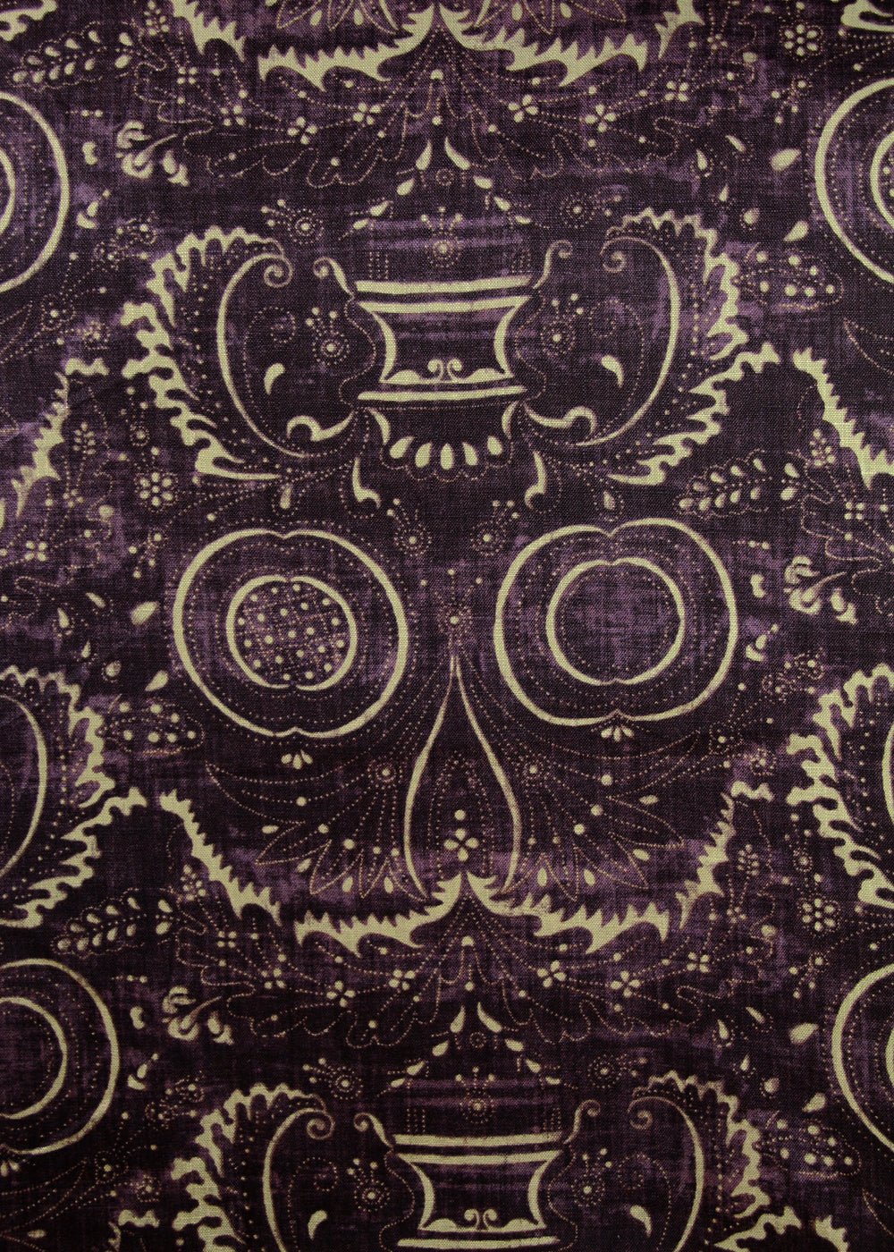 dark purple fabric with a swirly printed pattern