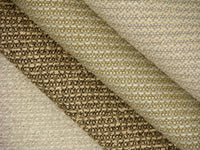 stack of upholstery boucle fabrics in shades of tan