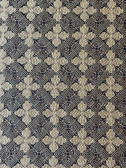 gold and black woven fabric with a tiled geometric design