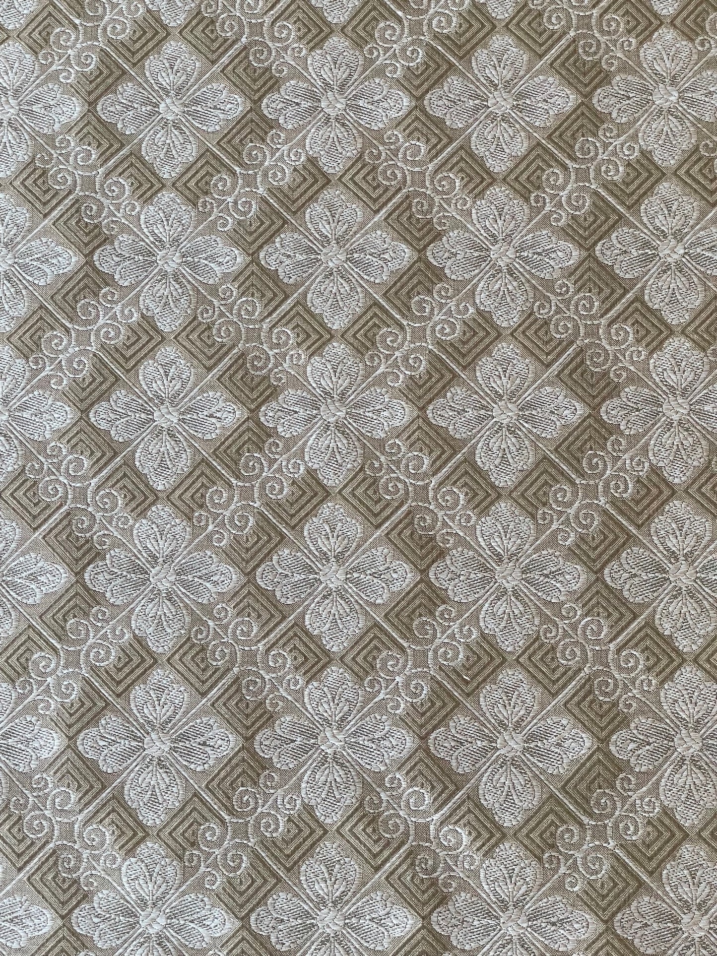 silver and taupe woven fabric with a tiled geometric design