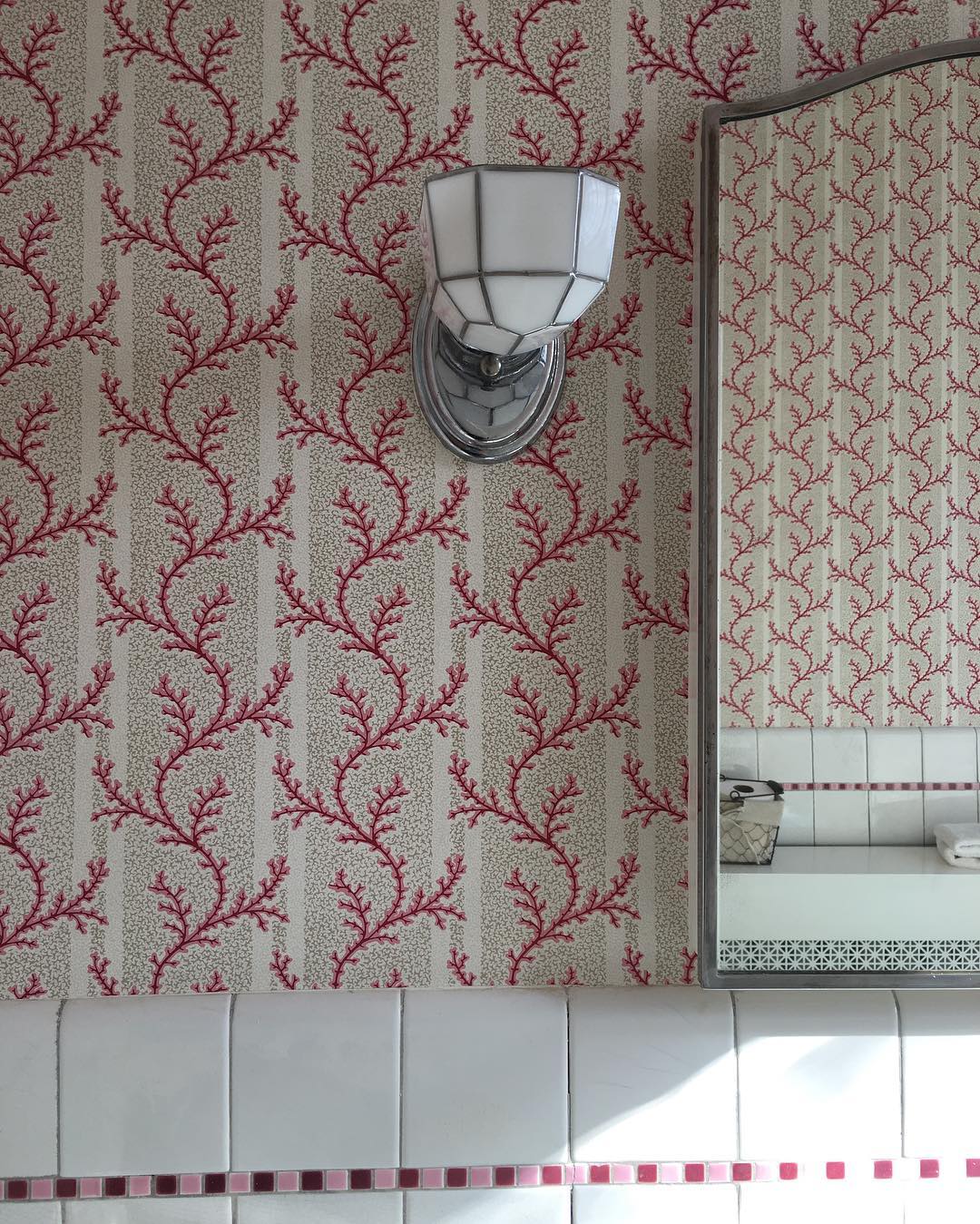 bathroom wallpapered with a pink coral printed wallpaper