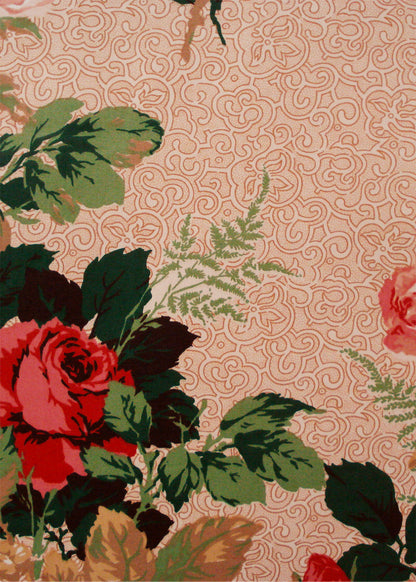 chintz fabric printed with roses over a pink swirled background