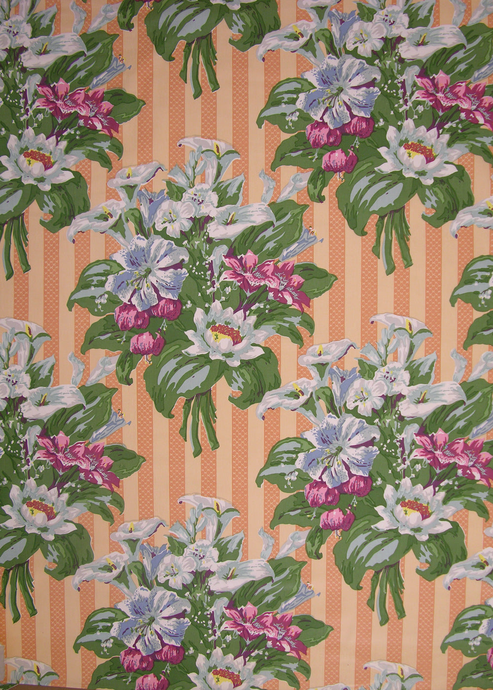 fabric printed with easter lilies on an orange striped background