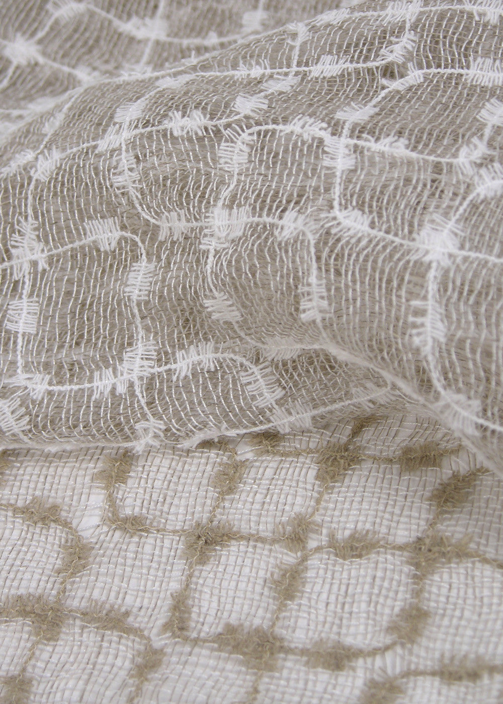close up of a sheer linen fabric with a unique mesh-like weave