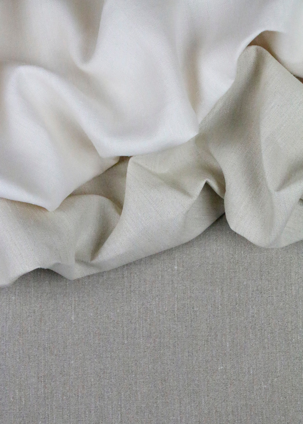 crumpled linen fabric in white, grey, and oatmeal colors