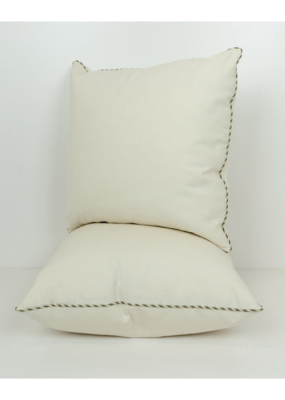 cream color pillows with a striped trim
