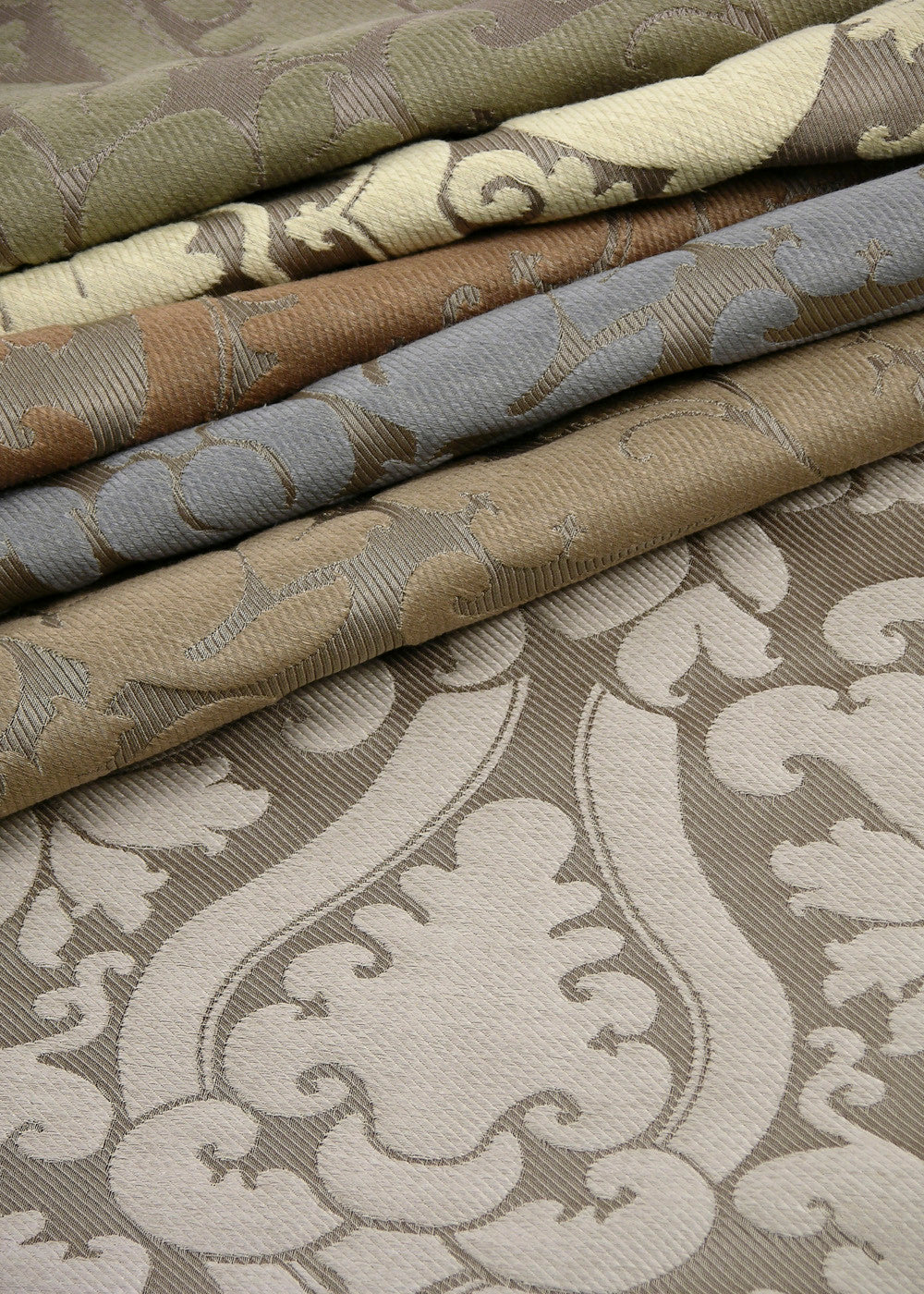 stack of fabrics with a woven damask design