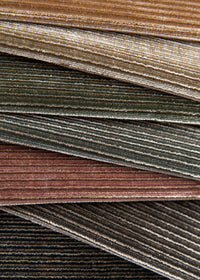 stack of jewel toned velvet fabrics with horizontal ribbed texture