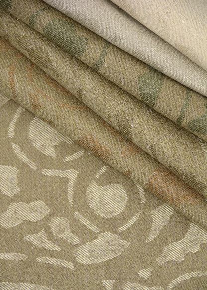 stack of natural colored fabric with a woven large-scale damask pattern