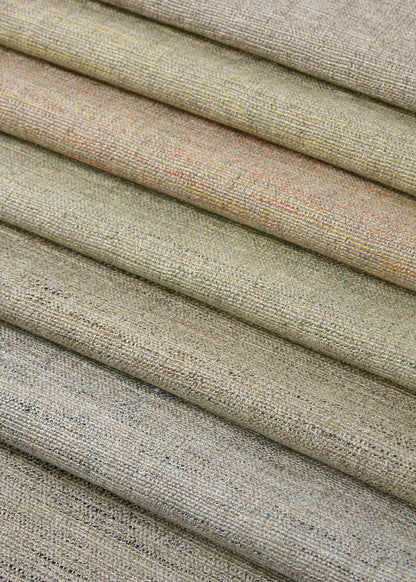 a stack of nubbly textured upholstery fabrics