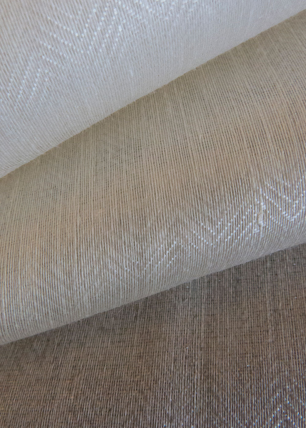 stack of herringbone weave sheer fabrics with a glazed finish