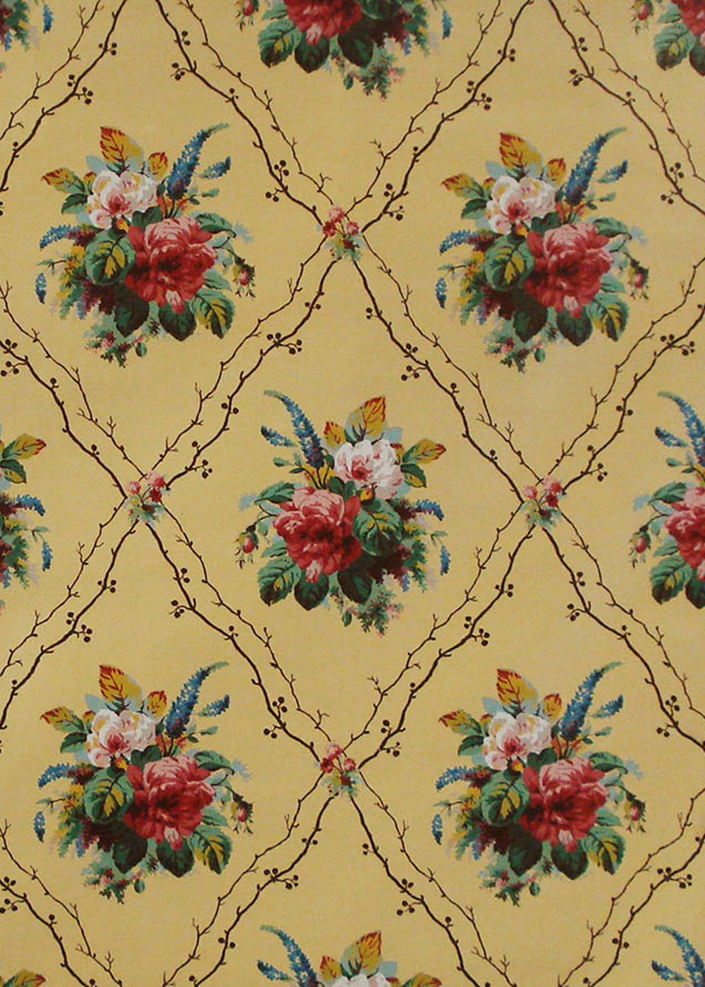 chintz fabric printed with bouquets of flowers and a diamond shaped trellis on yellow background