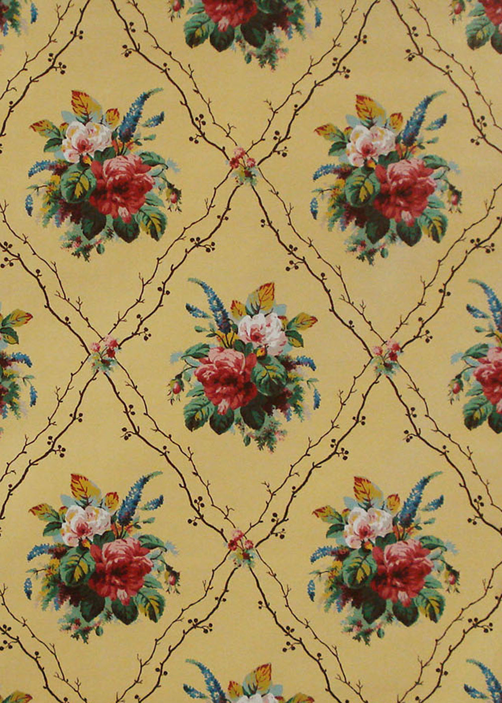 chintz fabric printed with bouquets of flowers and a diamond shaped trellis on yellow background