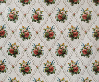 chintz fabric printed with bouquets of flowers and a diamond shaped trellis on white background