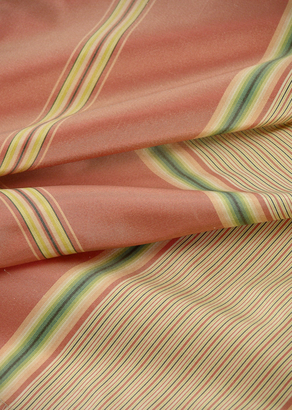 folded silk fabric with orange, yellow, and green stripes