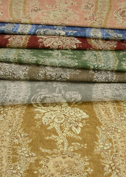 a stack of multicolored fabrics with tonal floral patterns