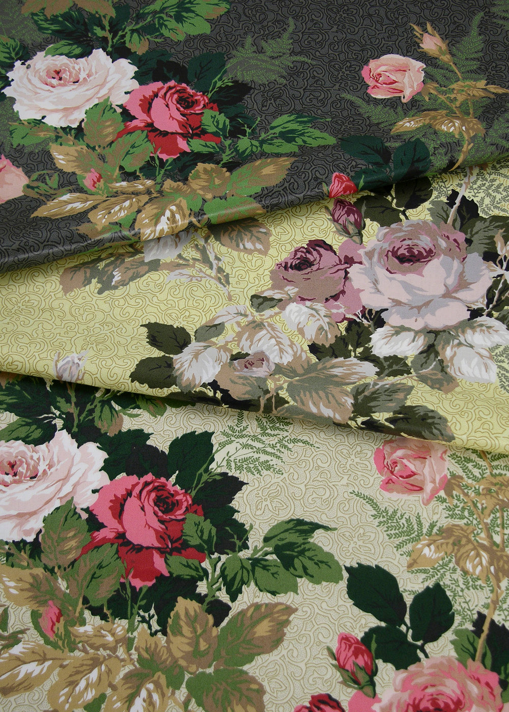 stack of chintz fabrics printed with roses, in several different colorways