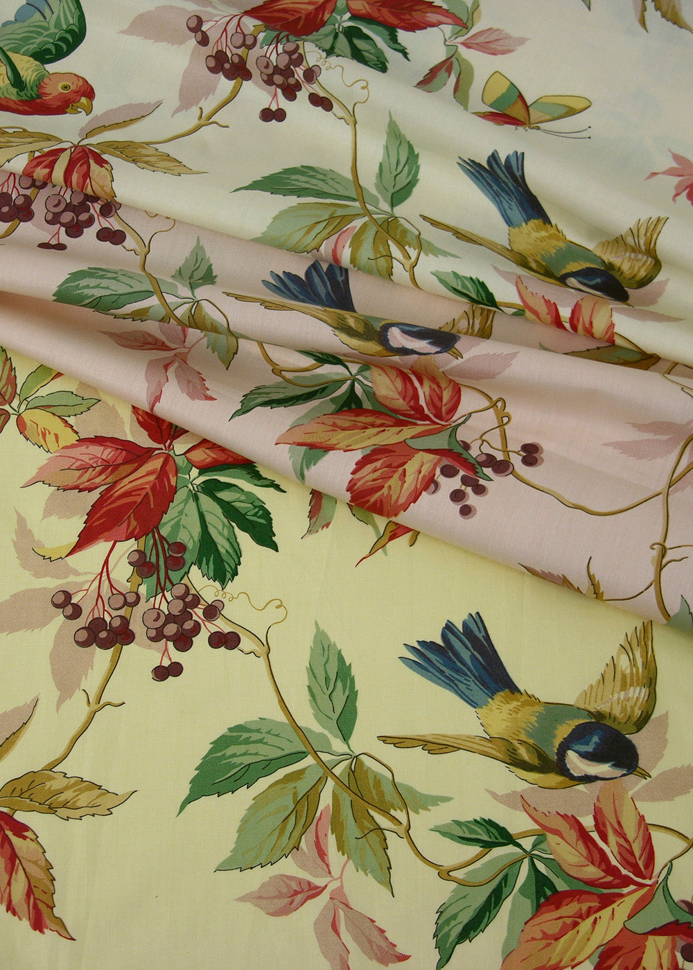 fabric that is printed with playful birds, butterflies, and flowers