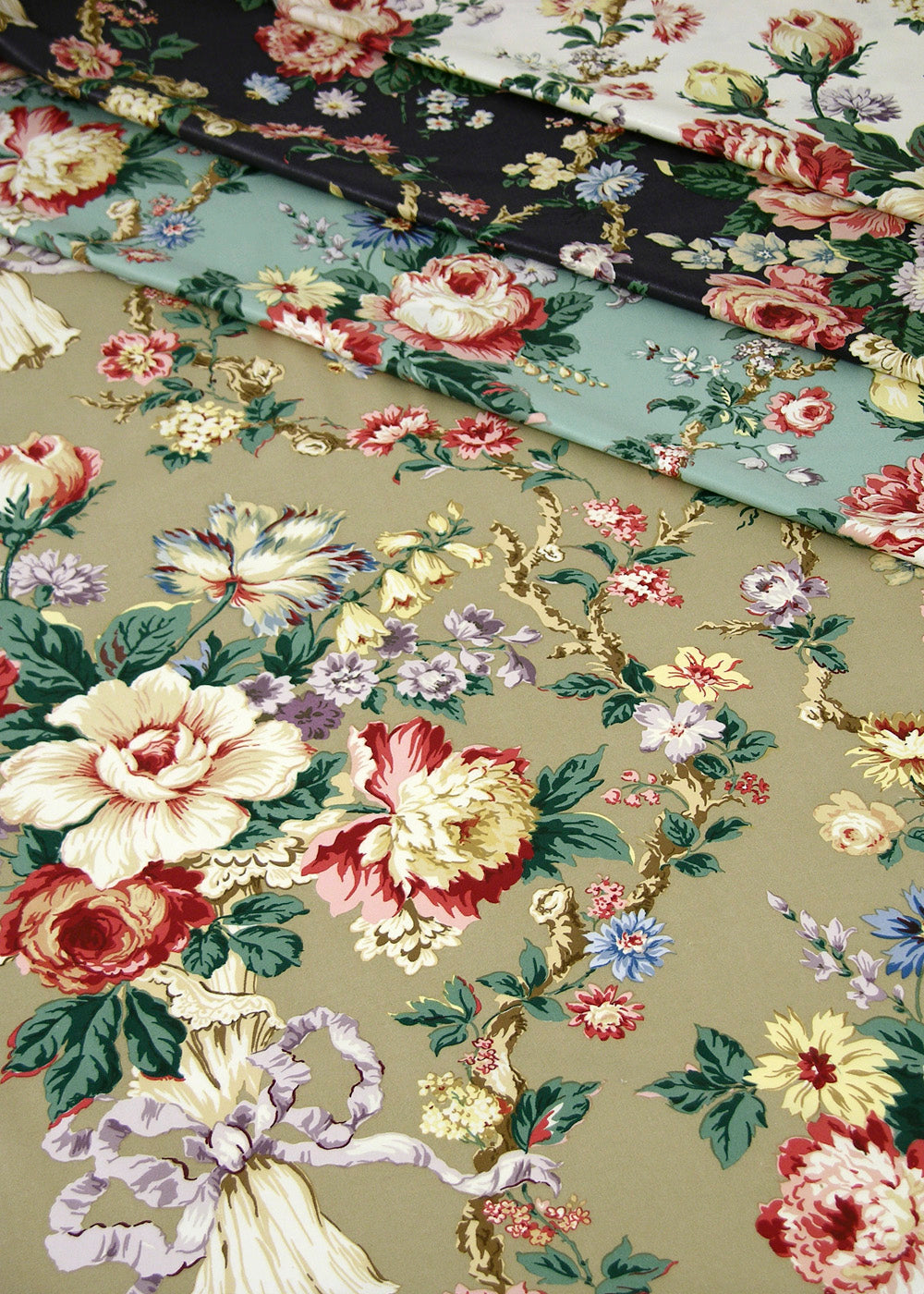 stack of floral chintz fabrics in several colorways